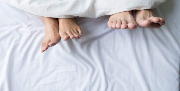 Feet of a couple sleeping side by side